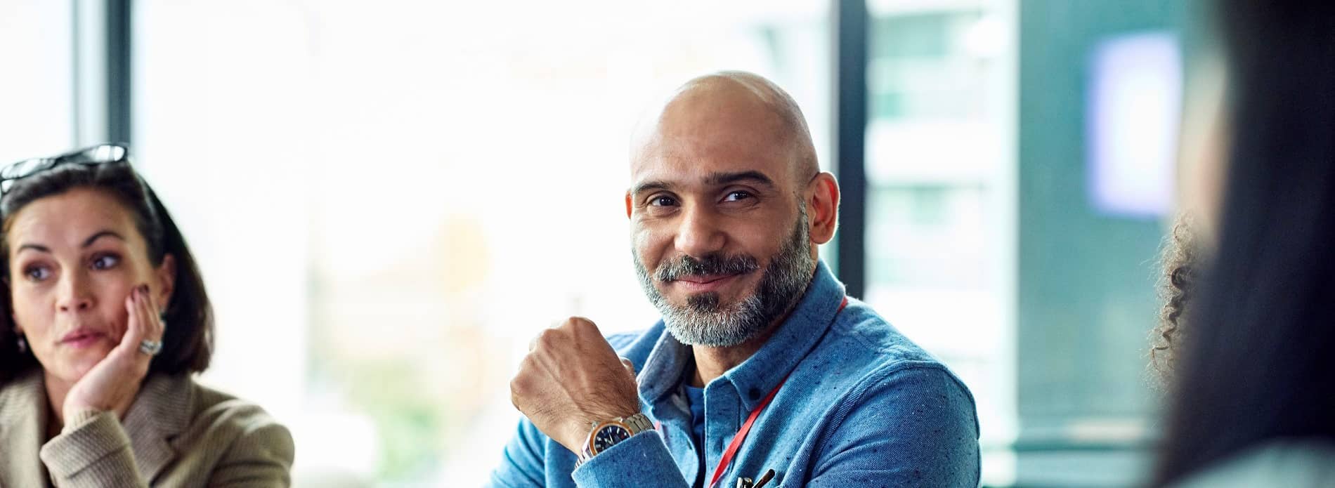Focus on man smiling in meeting