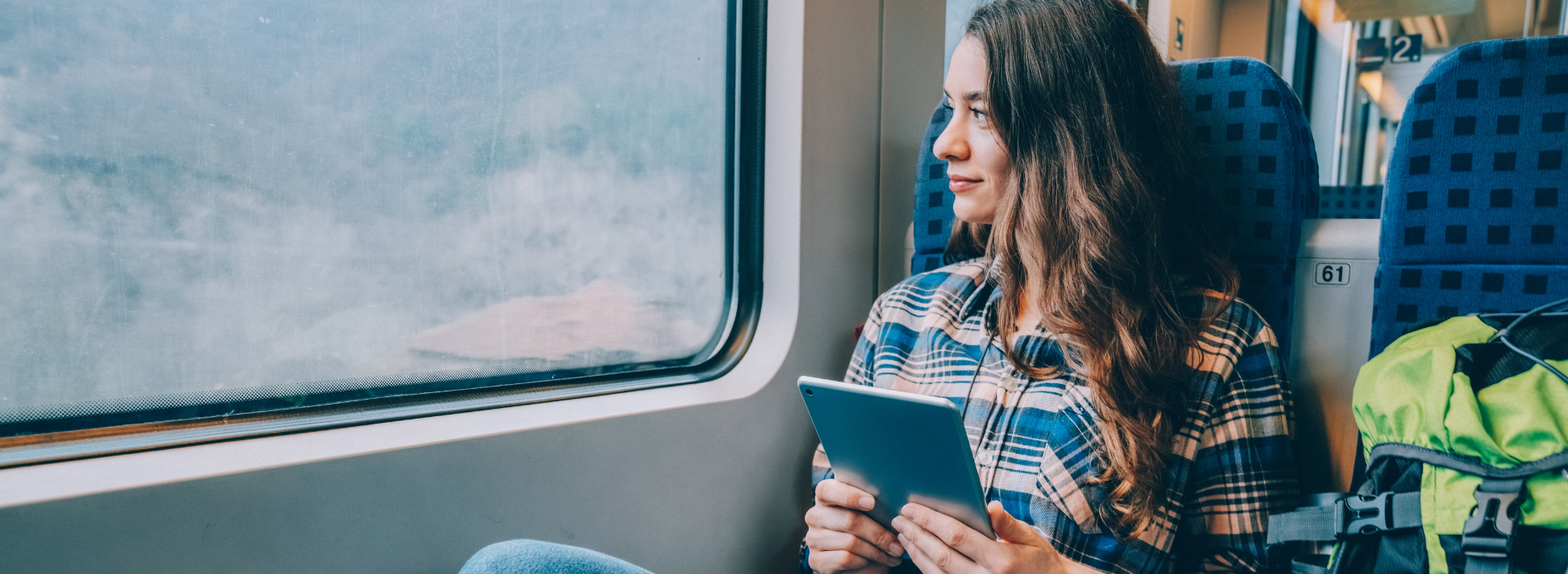 woman on train listening through headphones